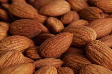 Photo of Many delicious ripe almonds as background, closeup
