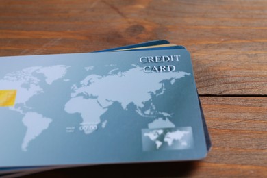 Many credit cards on wooden table, closeup