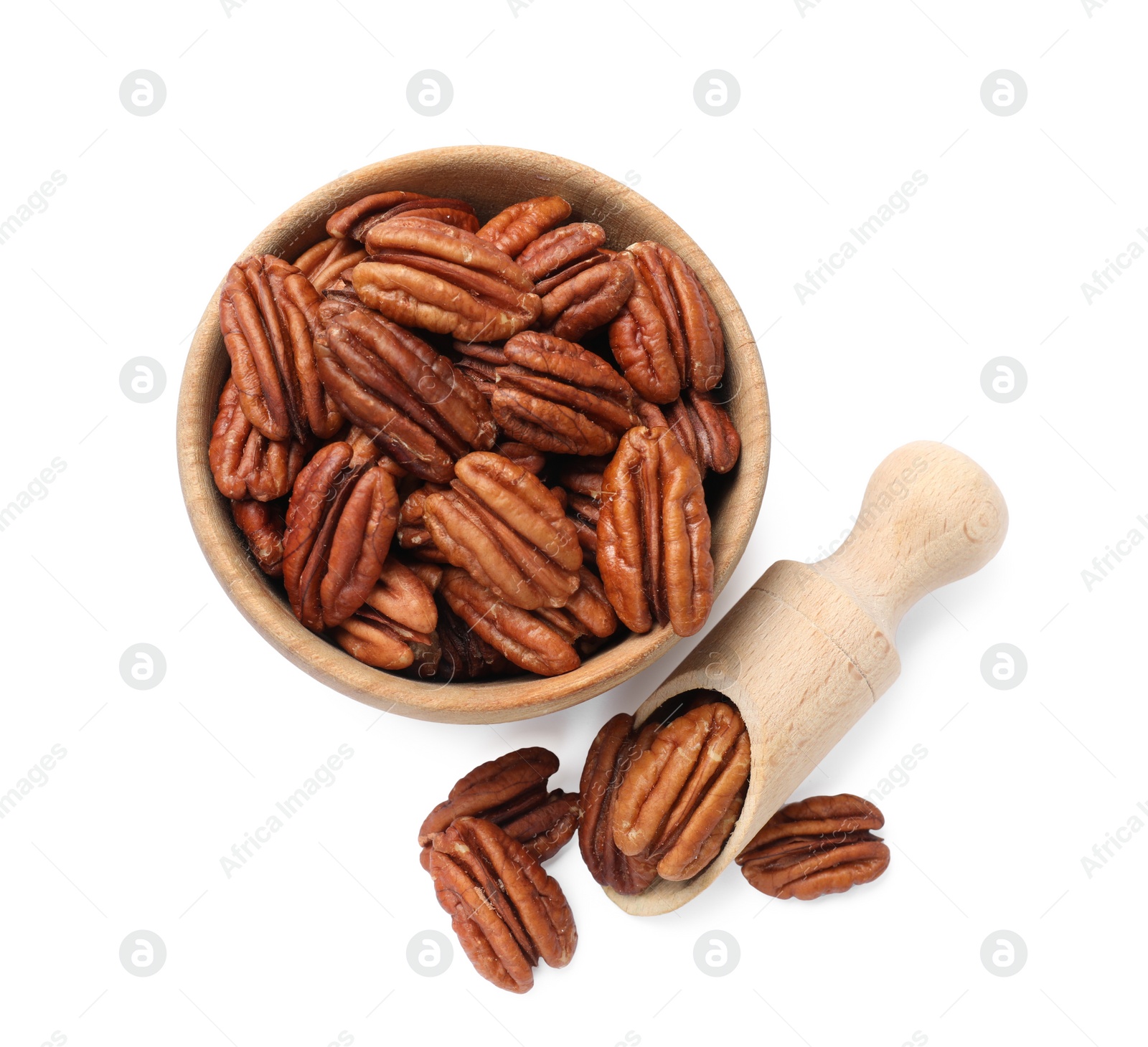 Photo of Tasty pecan nuts in bowl and scoop isolated on white, top view