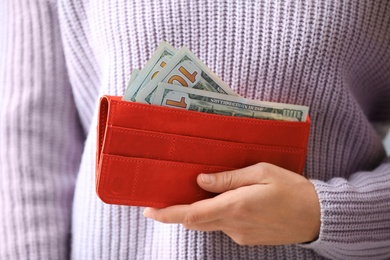 Photo of Woman with American money in wallet, closeup
