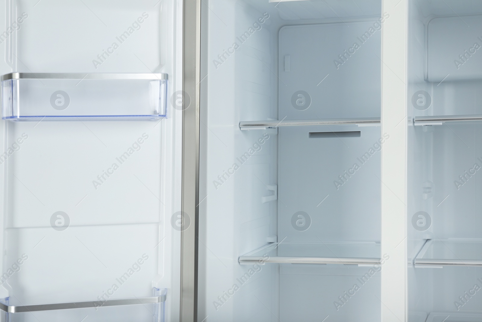 Photo of Shelves of empty modern refrigerator, closeup view