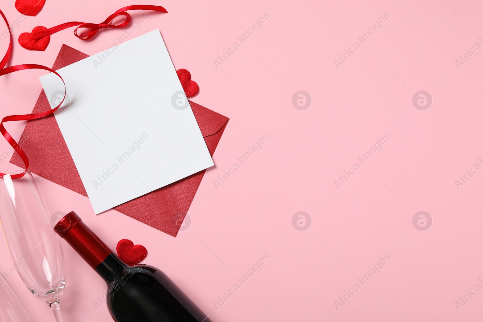 Photo of Flat lay composition with blank card on pink background, space for text. Valentine's Day celebration