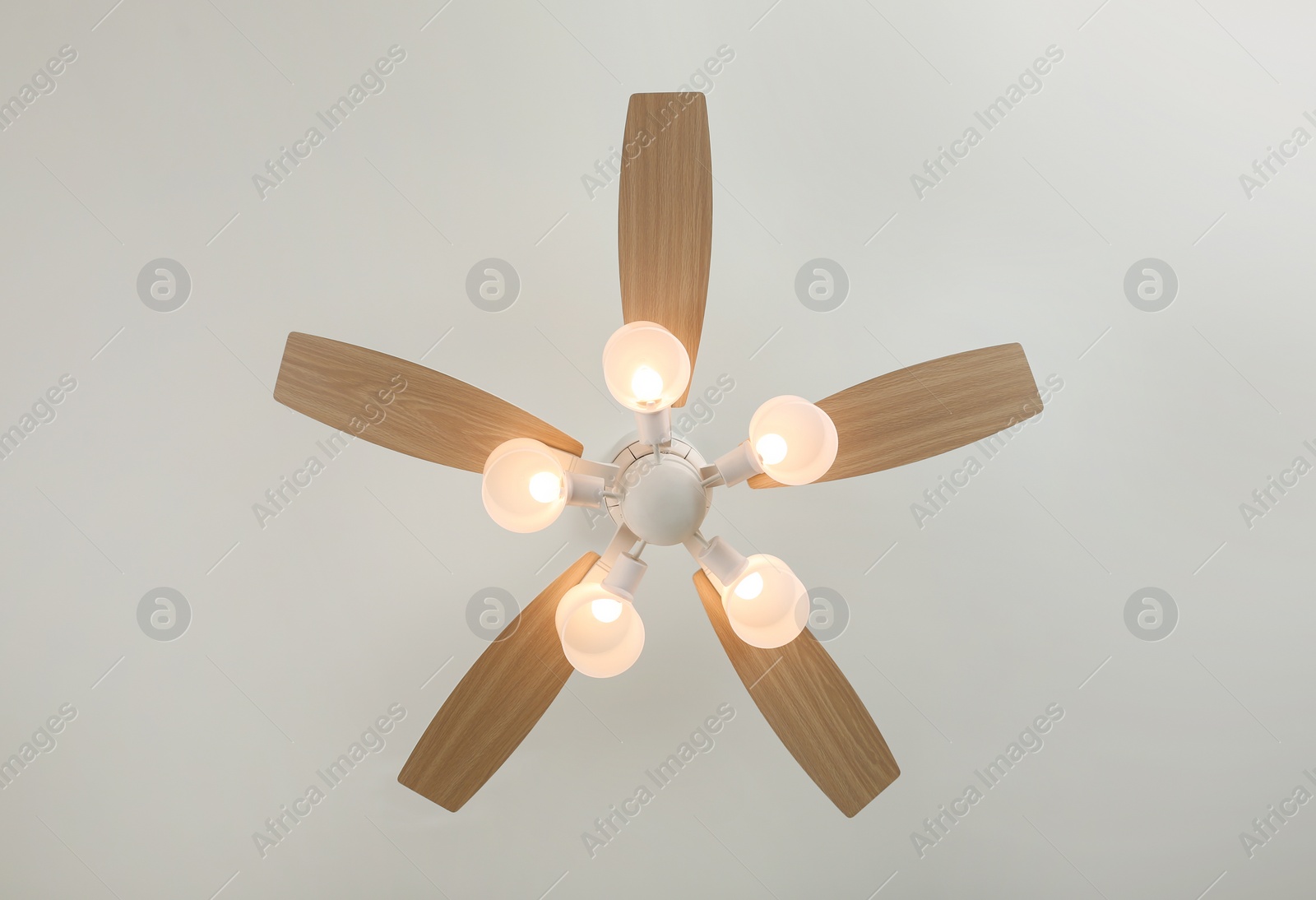 Photo of Modern ceiling fan with lamps indoors, bottom view. Interior element