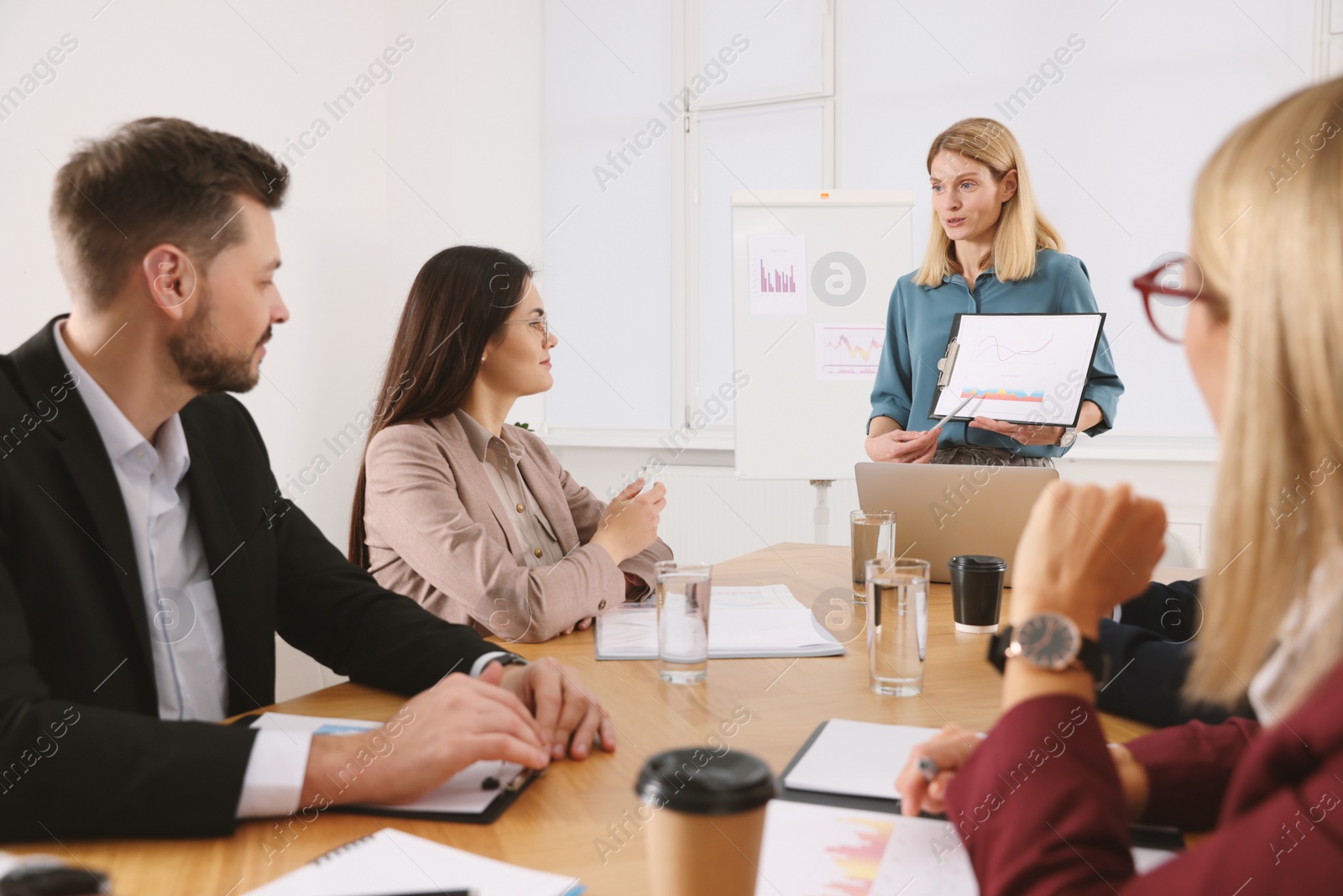 Photo of Businesswoman showing chart on meeting in office