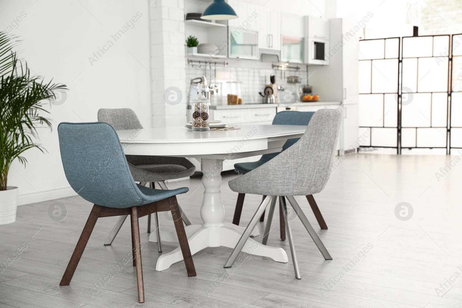 Photo of Stylish kitchen interior with dining table and chairs