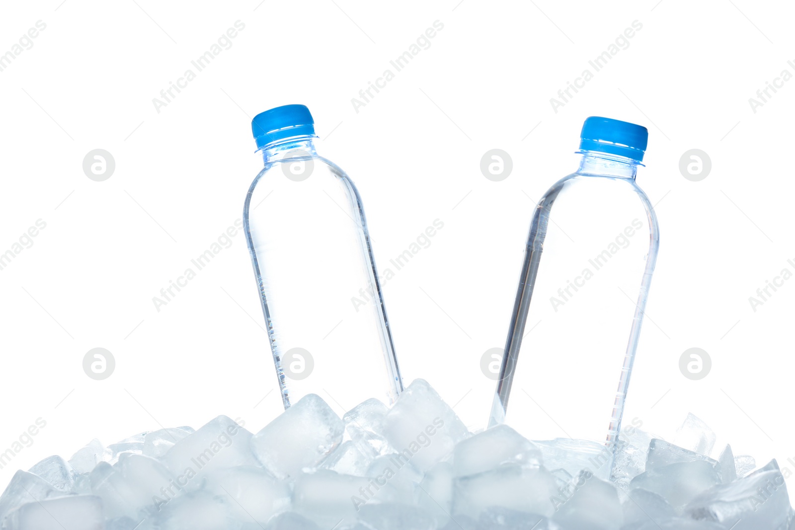 Photo of Bottles of water on ice cubes against white background