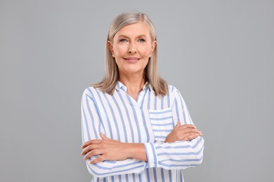 Photo of Portraitbeautiful middle aged woman on light grey background