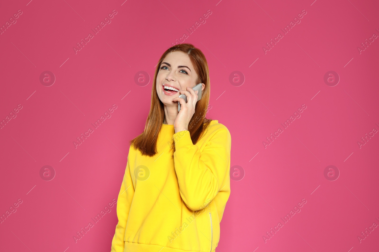 Photo of Portrait of beautiful woman talking on phone against color background