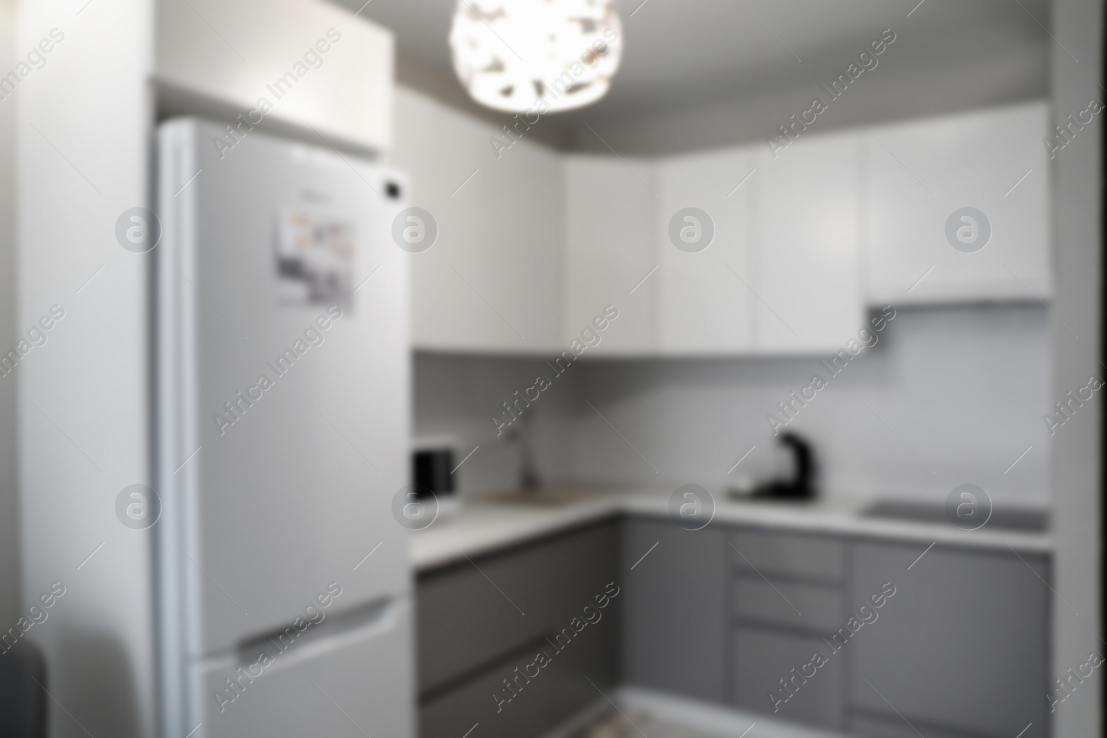 Photo of Blurred view of stylish modern kitchen interior