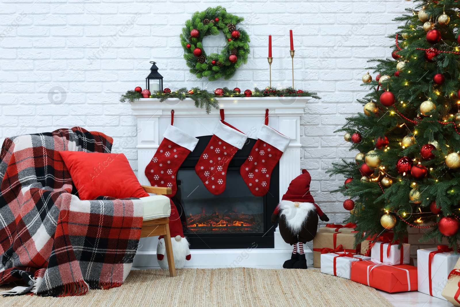 Photo of Cosy room with tree and fireplace decorated for Christmas. Interior design