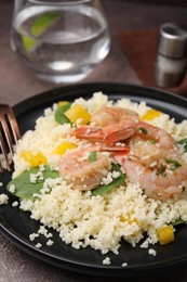 Tasty couscous with shrimps, bell pepper and basil on brown textured table