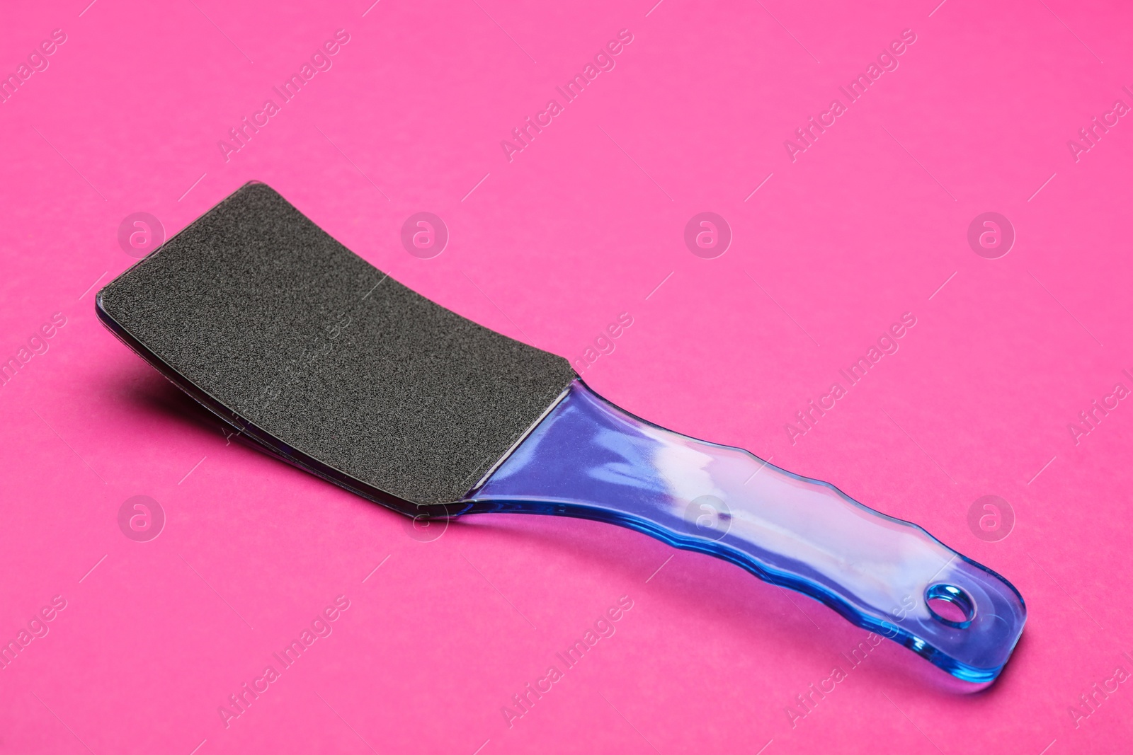 Photo of Blue foot file on pink background. Pedicure tool