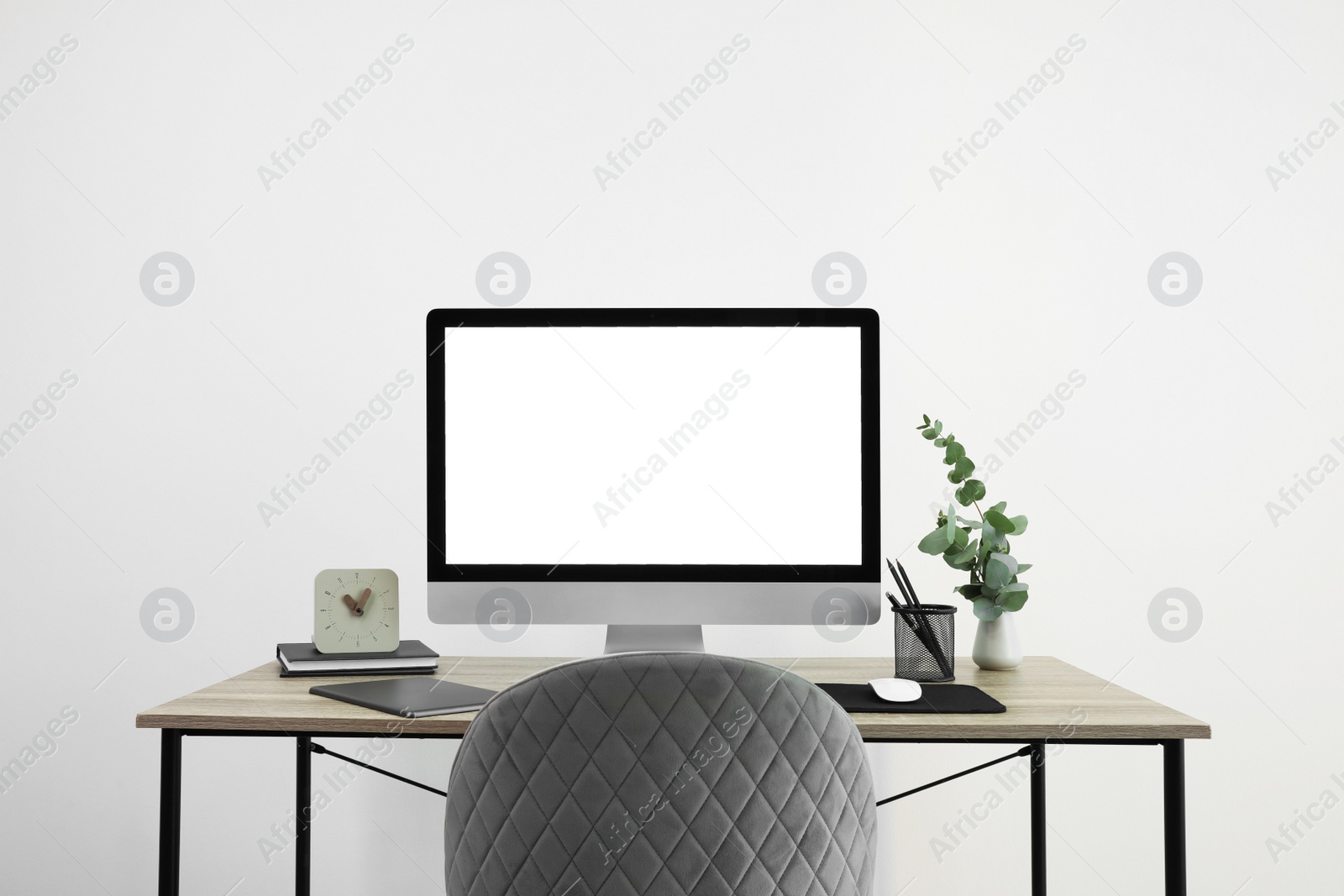 Photo of Modern computer with blank screen on desk, space for design. Comfortable workplace