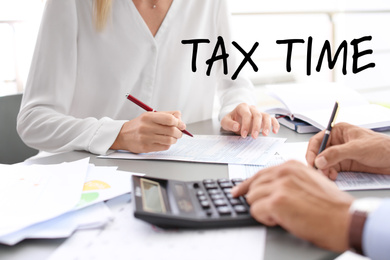 Tax accountants working with documents at table, closeup