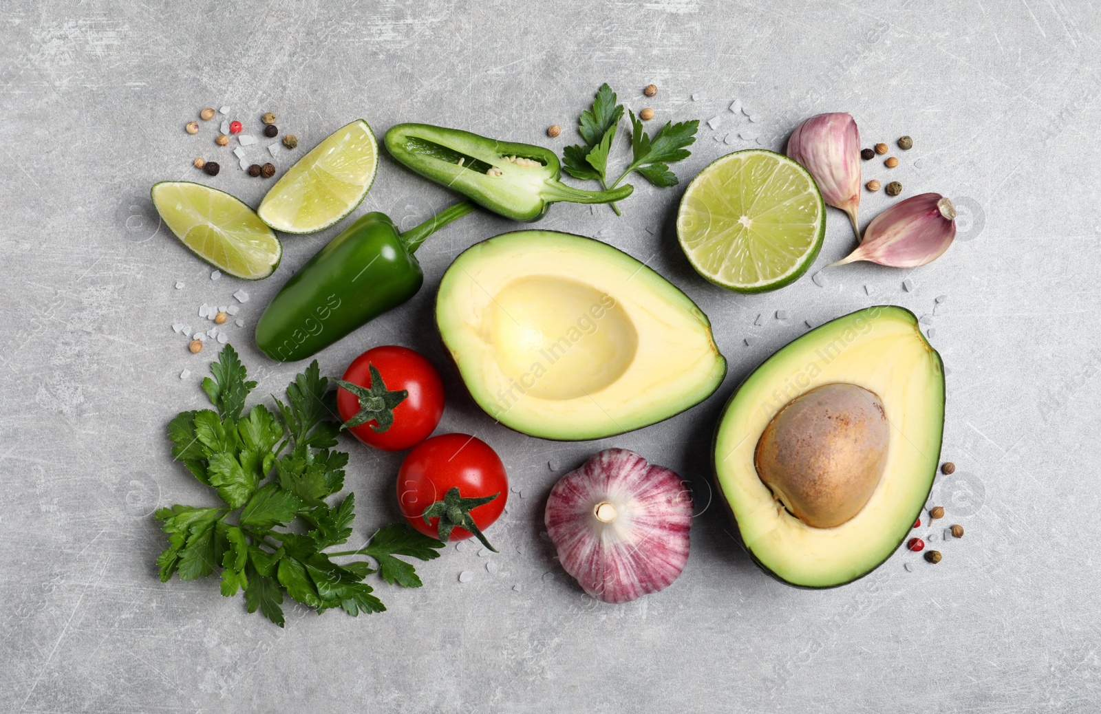 Photo of Fresh ingredients for guacamole on light grey table, flat lay