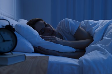 Handsome man sleeping in bed at night