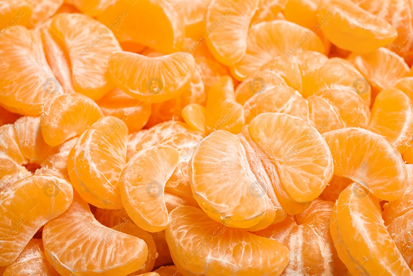 Photo of Peeled fresh ripe tangerines as background, closeup