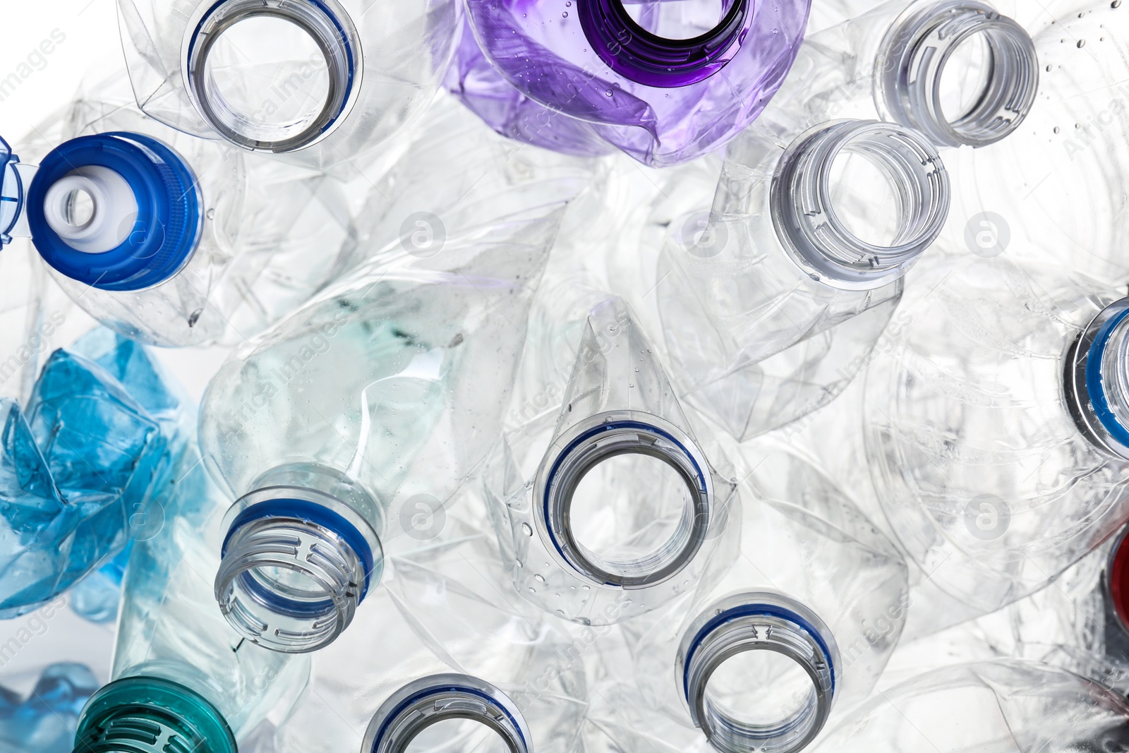 Photo of Many crumpled bottles as background, closeup. Plastic recycling