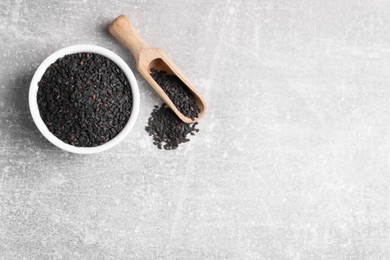 Photo of Black sesame seeds on grey table, flat lay. Space for text