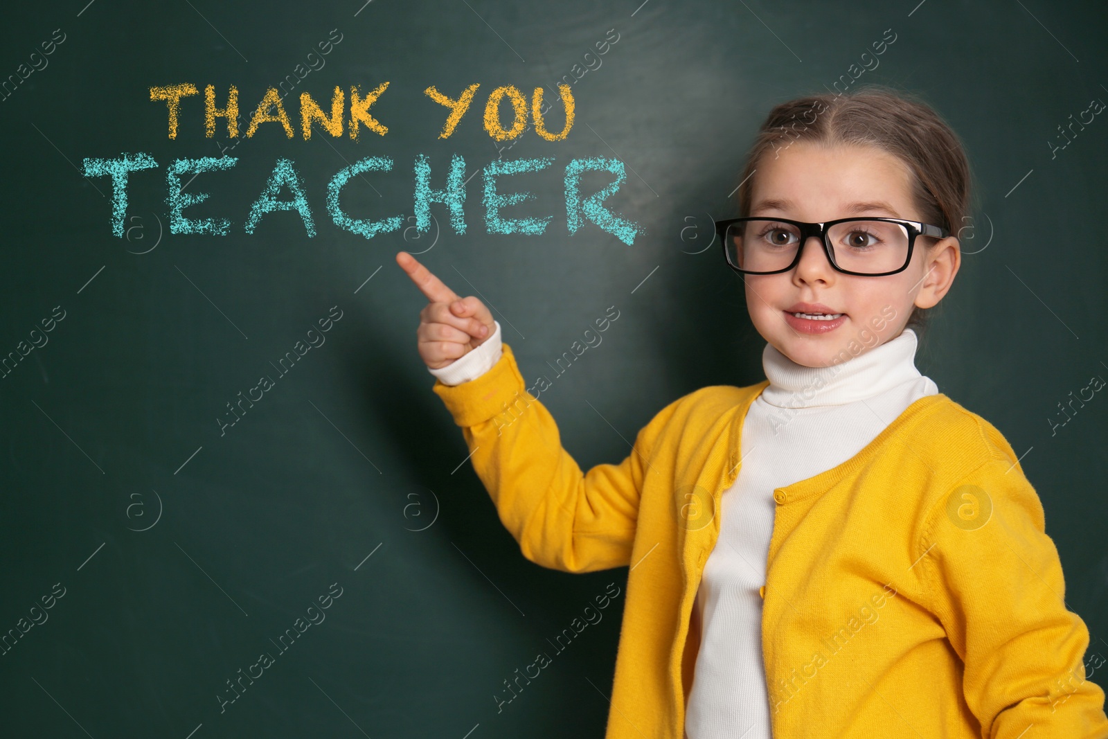 Image of Cute little girl near chalkboard with phrase Thank You Teacher