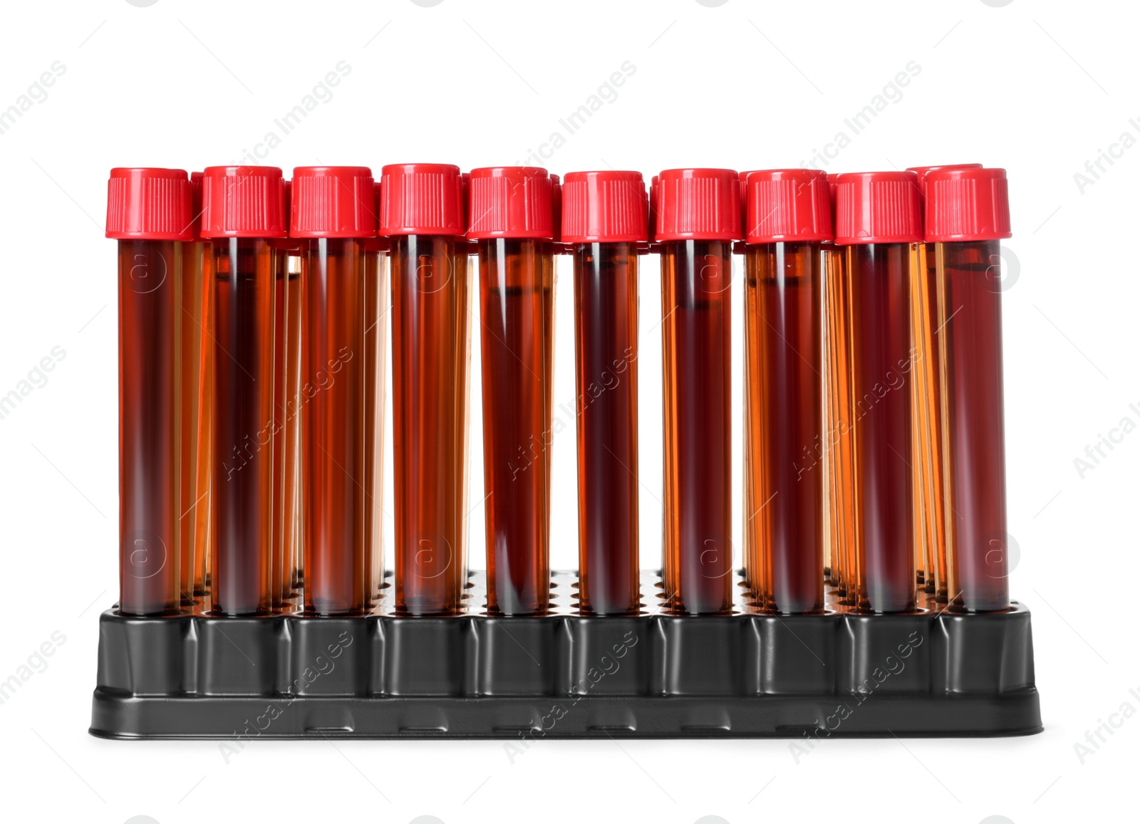 Photo of Test tubes with brown liquid in stand on white background