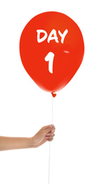 Starting new life chapter. Woman holding red balloon with text Day 1 on white background, closeup