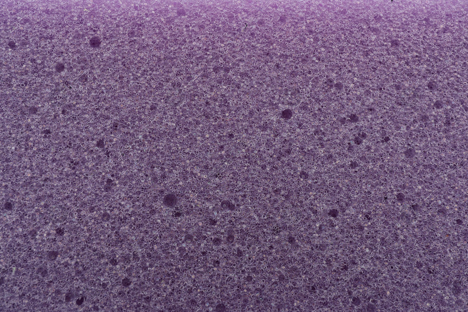 Photo of Purple cleaning sponge as background, top view