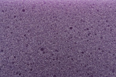 Photo of Purple cleaning sponge as background, top view