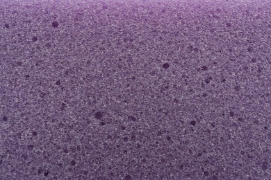 Purple cleaning sponge as background, top view