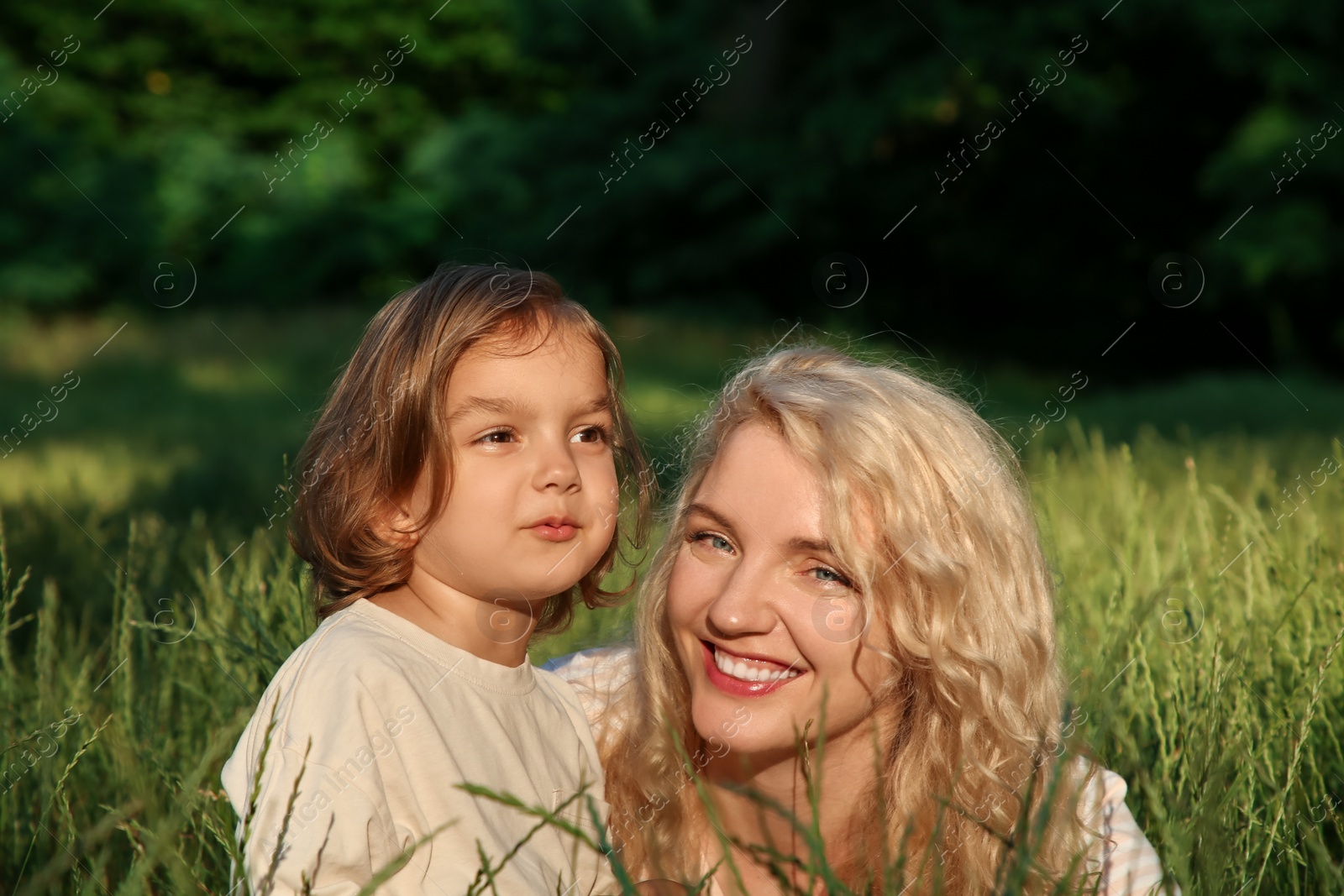 Photo of Happy mother with her cute daughter spending time together outdoors