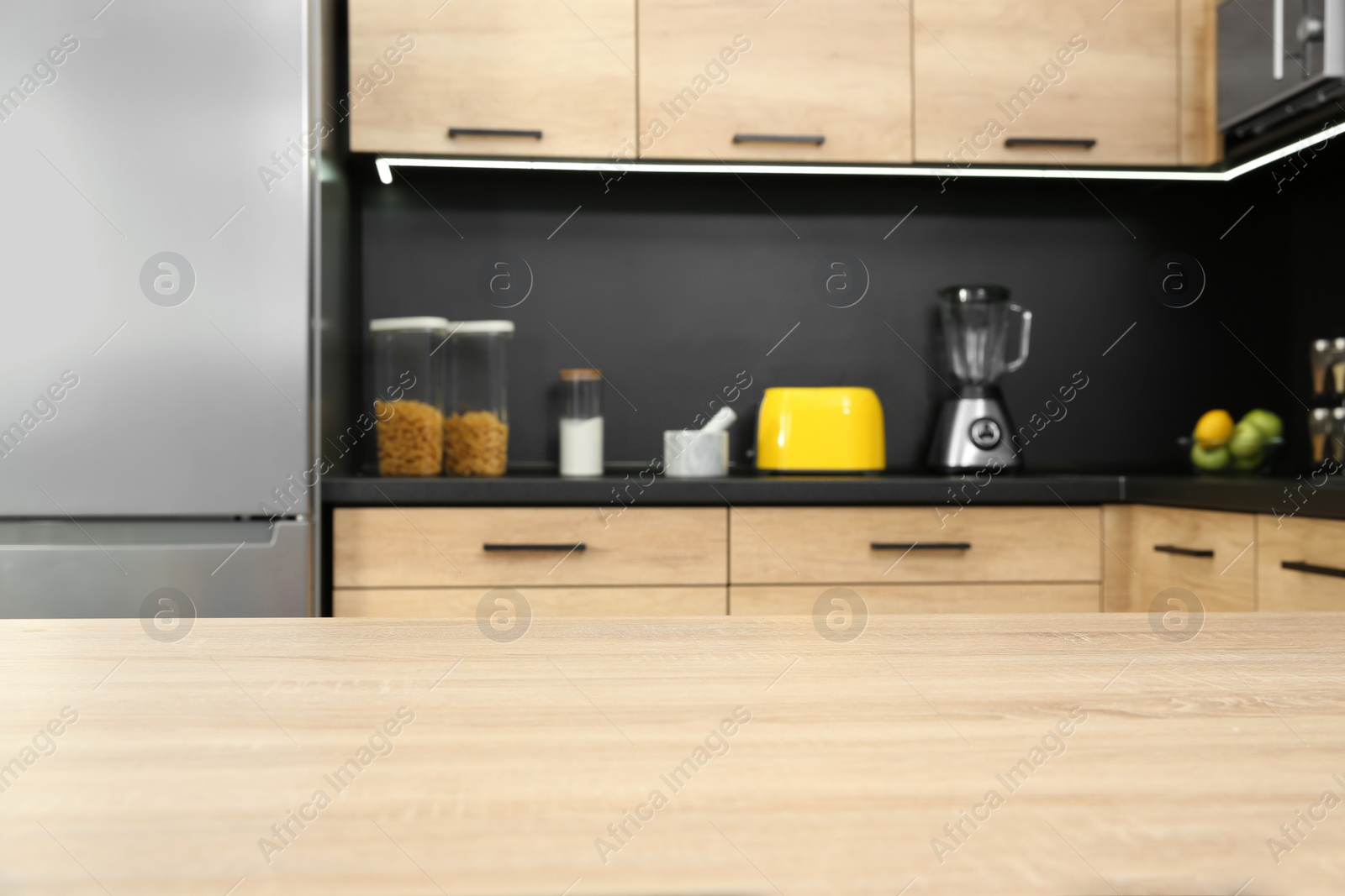 Photo of Countertop and blurred view of kitchen interior on background