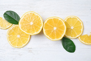 Photo of Flat lay composition with fresh ripe lemons on white wooden table