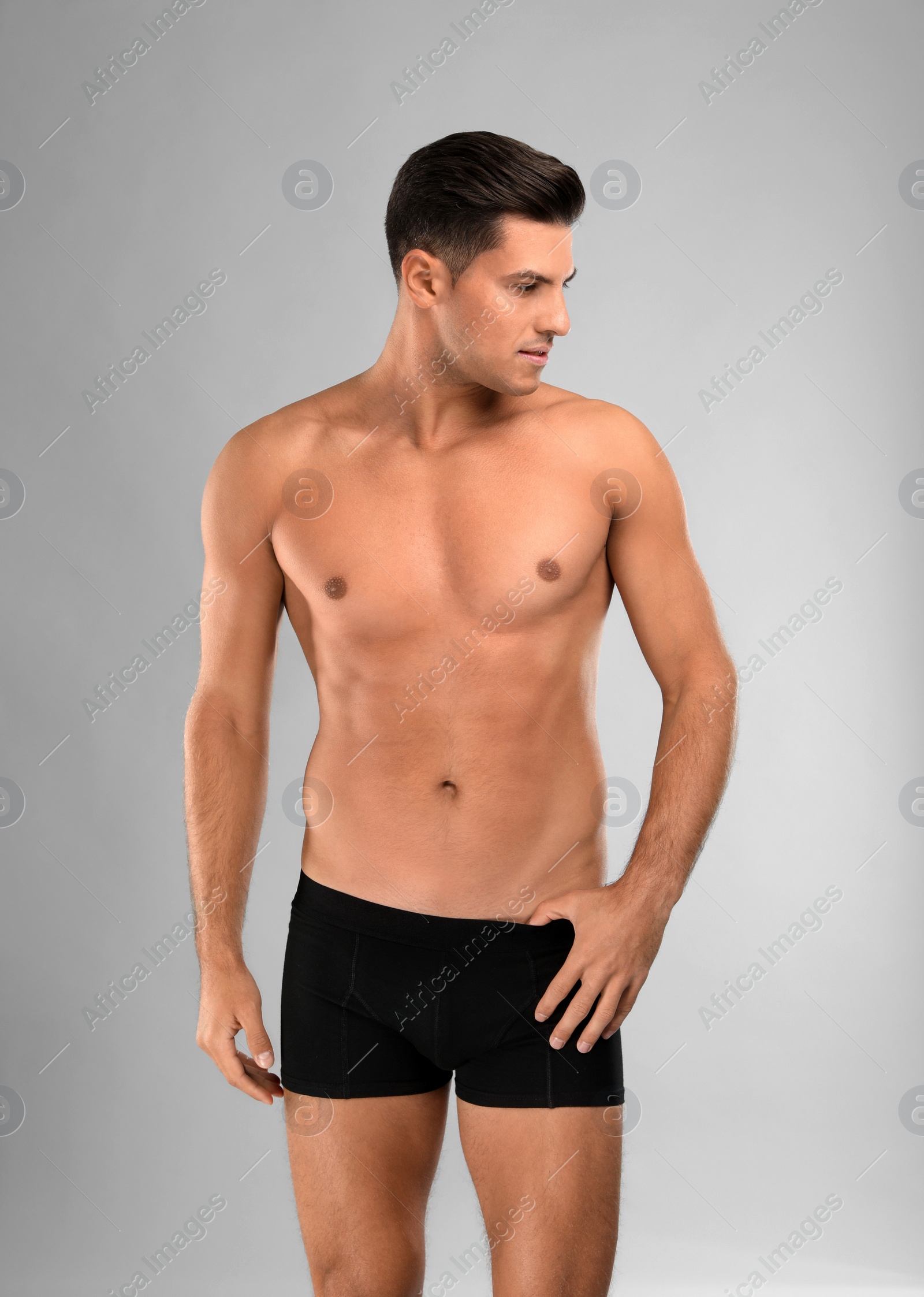 Photo of Handsome man in black underwear on light grey background