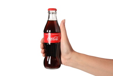 MYKOLAIV, UKRAINE - NOVEMBER 14, 2018: Woman holding bottle of Coca-Cola on white background