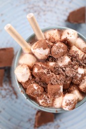 Photo of Cup of aromatic hot chocolate with marshmallows and cocoa powder on table, top view