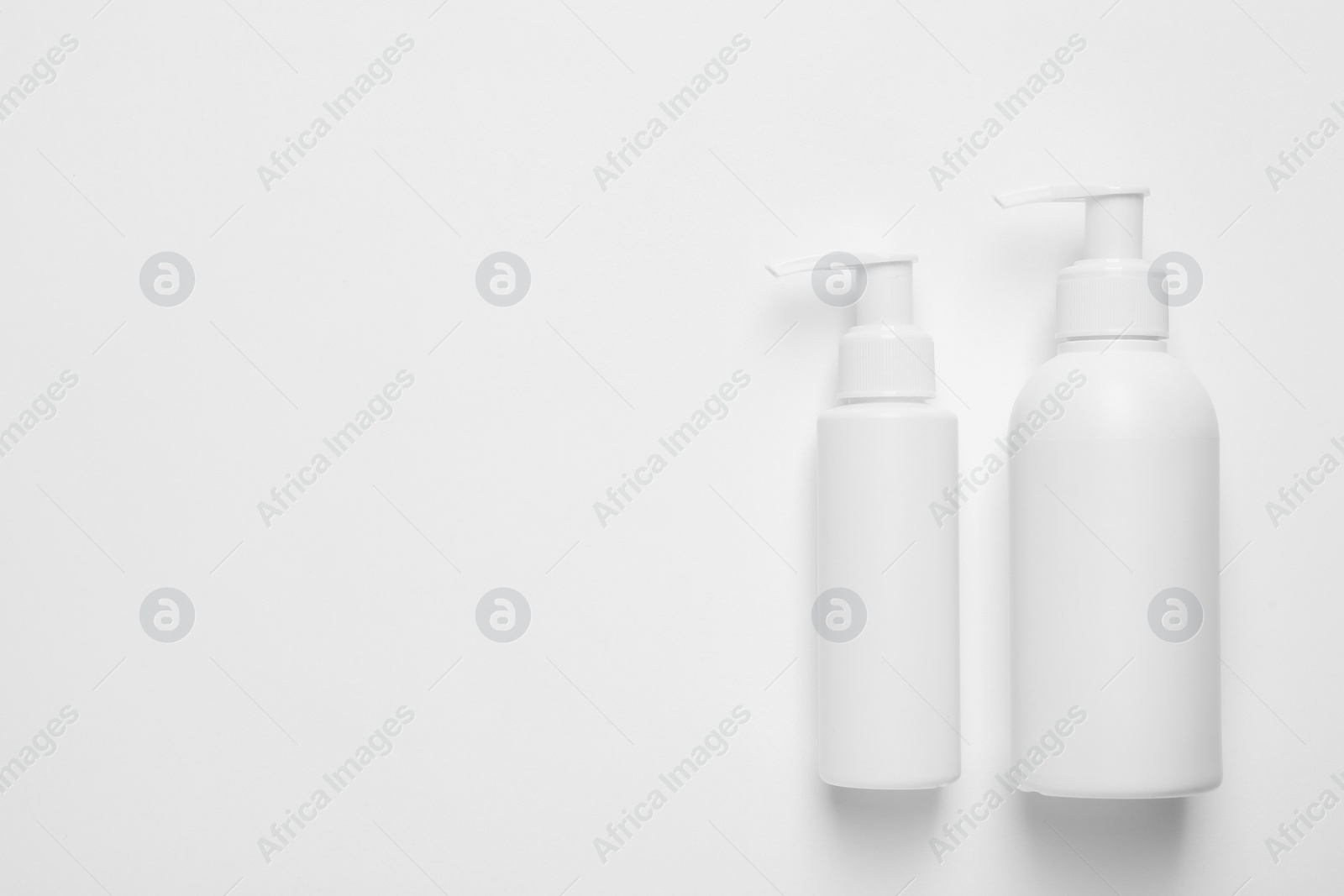 Photo of Different cleansers on white background, flat lay with space for text. Cosmetic product