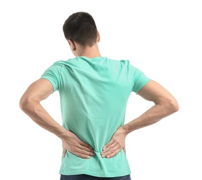 Young man suffering from back pain on white background