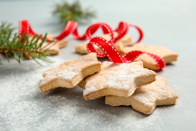 Photo of Tasty homemade Christmas cookies with ribbon on table