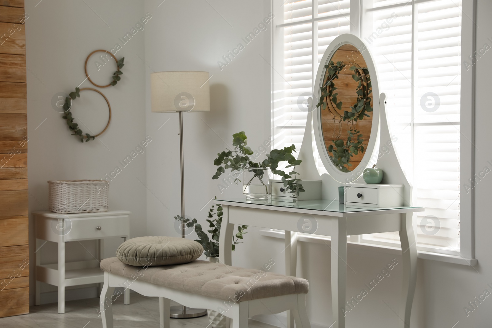 Photo of Stylish dressing table decorated with beautiful eucalyptus branches indoors