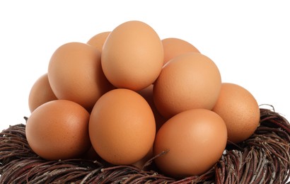 Photo of Chicken eggs and nest isolated on white