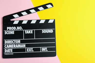 Photo of Clapper board on color background, top view with space for text. Cinema production