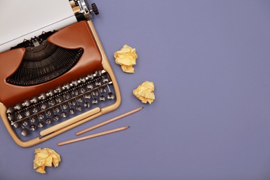 Photo of Vintage typewriter, pencils and crumpled paper on grey background, flat lay. Space for text