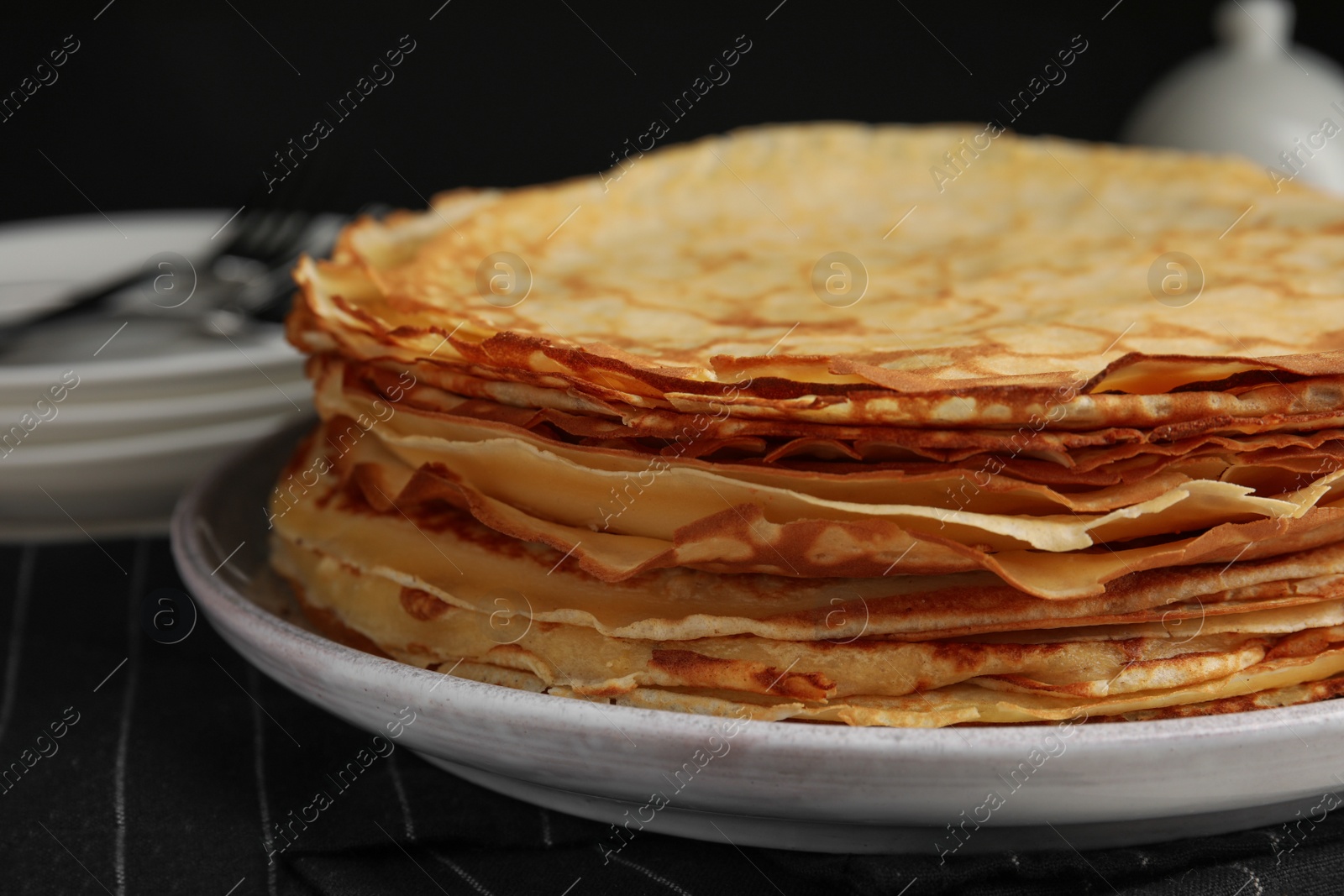 Photo of Stack of fresh thin pancakes on table, closeup