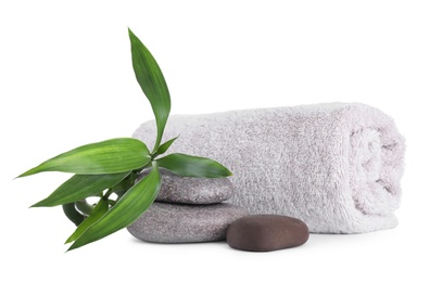 Photo of Towel, bamboo sprout and spa stones isolated on white