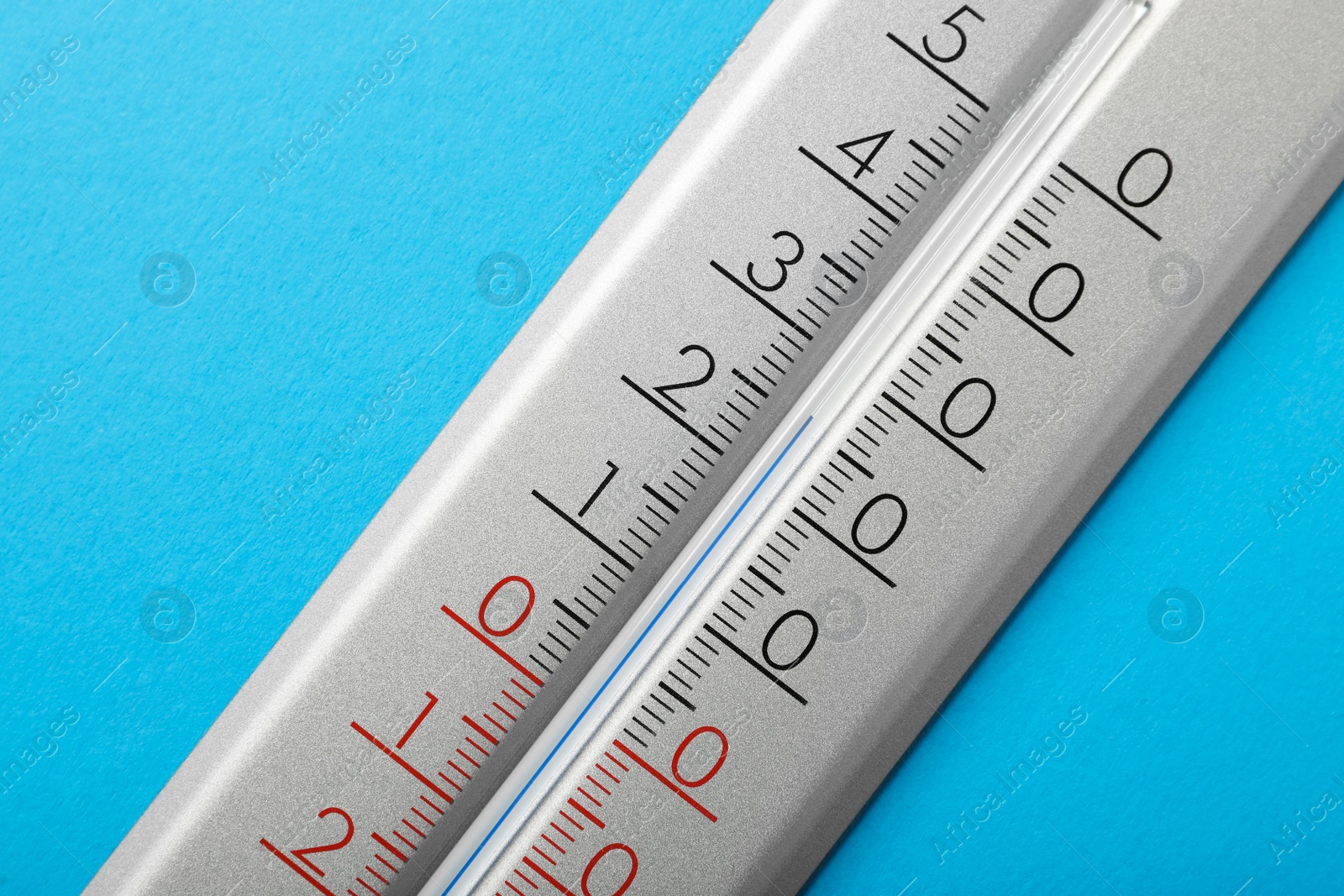 Photo of Weather thermometer on light blue background, closeup