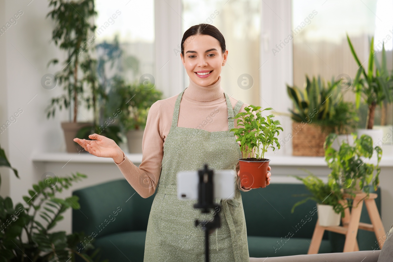 Photo of Teacher conducting online gardening course at home. Time for hobby