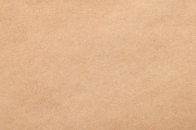 Photo of Texture of beige paper sheet as background, top view