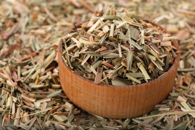 Wooden bowl and aromatic dried lemongrass, closeup