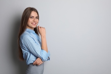 Photo of Beautiful real estate agent on grey background