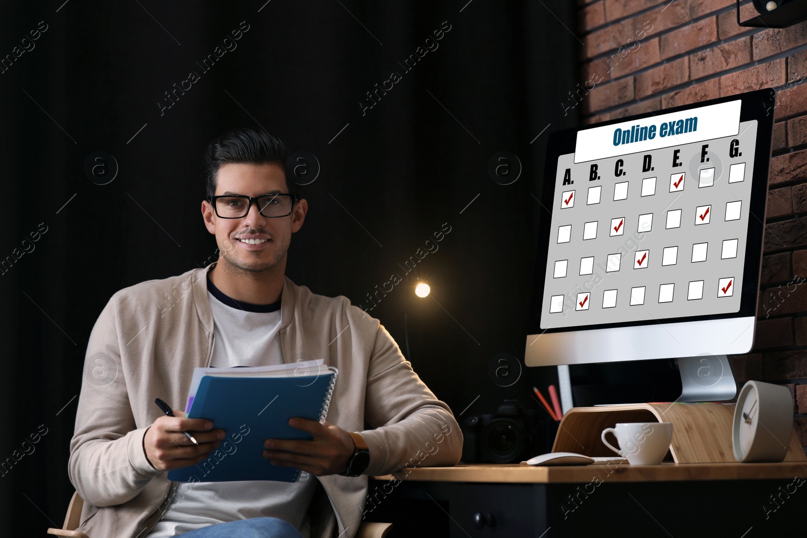 Image of Student with notebook at workplace at home. Online exam